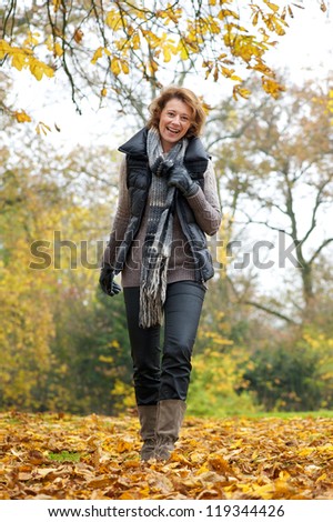 Full length portrait of a woman walking in the park