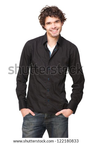 Handsome young male model smiling and looking at the camera happy man is in a casual pose with his hands in his pockets. Isolated on white background