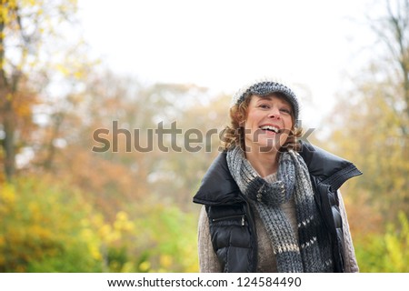 Portrait of an beautiful older woman smiling in the park