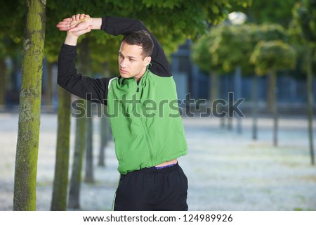 Portrait of a healthy young man stretching before a work out