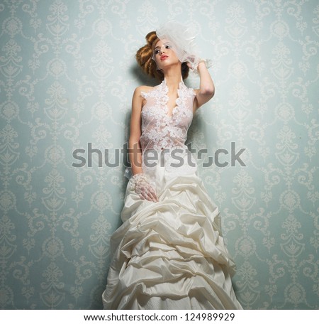 Beautiful bride with elegant white wedding dress with hand to head