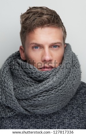 Close up portrait of a handsome man with wool scarf