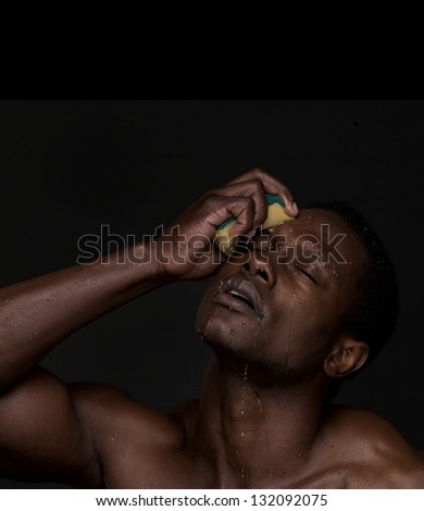 Portrait of a handsome african american man washing face