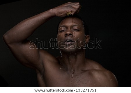 Portrait of a man washing face with water