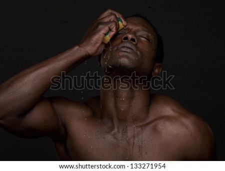 Portrait of a sexy man washing face