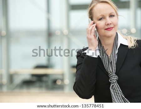 Close up portrait of a business woman talking on cellphone outdoors