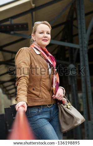Portrait of an attractive middle aged woman standing outdoors