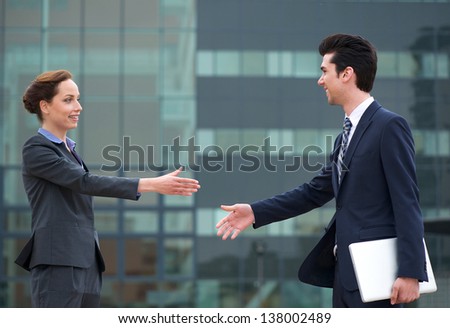 Portrait of a businessman and business woman meeting with a handshake