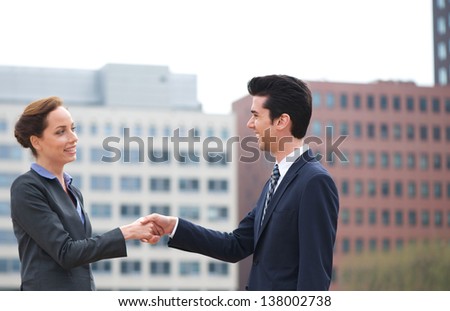 Portrait of a businessman and business woman handshake greeting