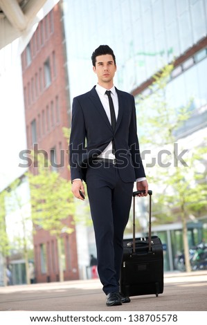 Portrait of a businessman traveling with bag