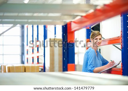 Portrait of a businesswoman  controlling inventory in a warehouse