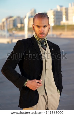 Close up portrait of a trendy young man standing outdoors