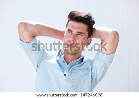 Portrait of an attractive male fashion model with hands in hair