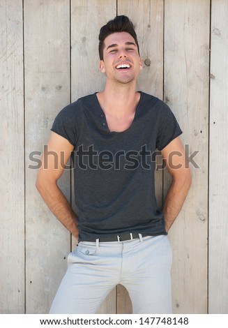 Portrait of a cute young guy smiling outdoors