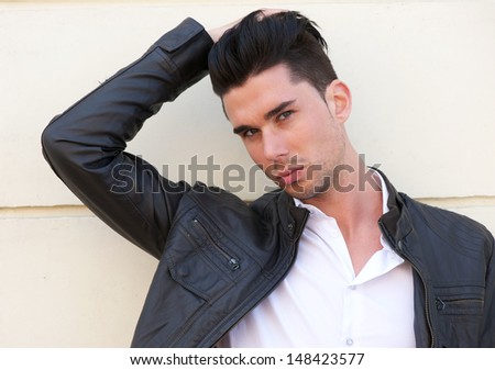 Closeup portrait of an attractive male model with hand in hair