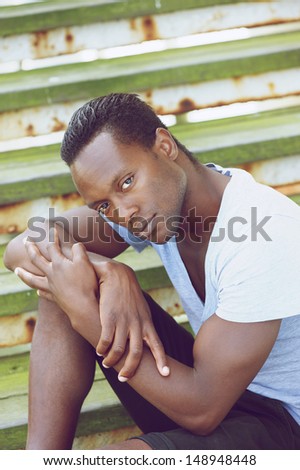 Closeup portrait of an african american fashion model sitting on stairs outdoors