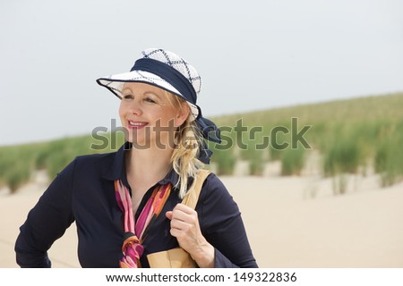 Closeup portrait of a beautiful older woman smiling at the beach