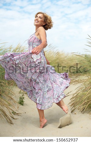 Portrait of an active older woman dancing at the beach