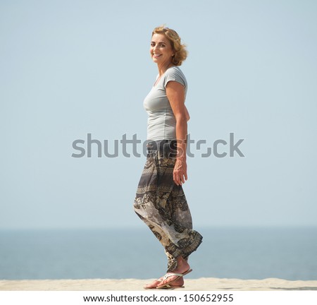 Portrait of an active older woman walking at the beach