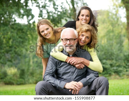 Fun portrait of a happy family laughing together outdoors