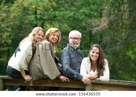 Portrait of a happy family smiling together in the forest