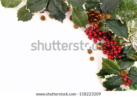 Closeup christmas decoration arrangement with holly, berries and pine cones
