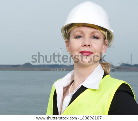 Close up portrait of a female industry inspector in hard had and safety vest