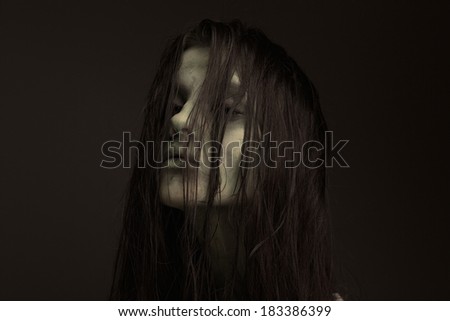 Close up portrait of a evil woman possessed by the devil. Zombie concept, fear of the monster