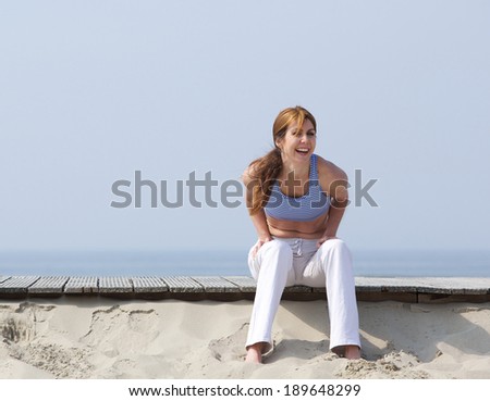 Portrait of a middle aged woman laughing at the beach