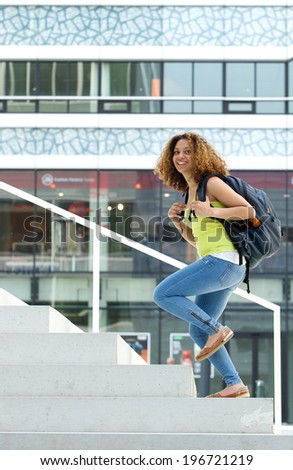 Portrait of a female student walking up stairs to college Portrait of a female student walking up stairs to college