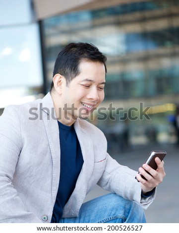 Portrait of an asian man smiling with mobile phone
