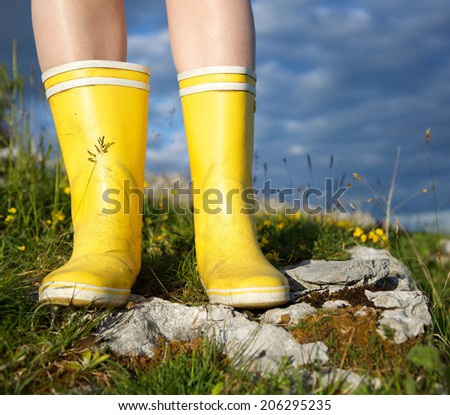 Low angle view of woman standing in boots outdoors