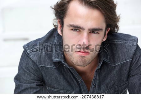 Close up portrait of a handsome young man with stubble