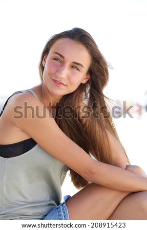 Close up portrait of a beautiful young woman sitting outside