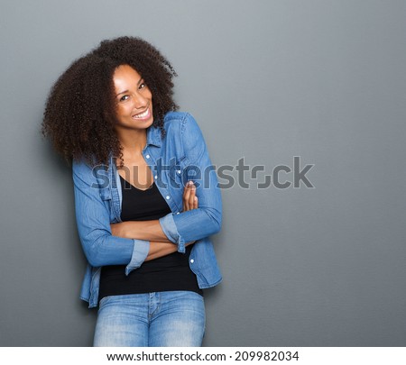 Portrait of a happy young african american woman posing with arms crossed
