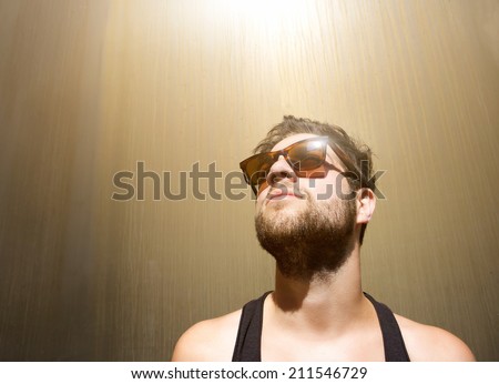 Close up portrait of a cool guy posing with sunglasses