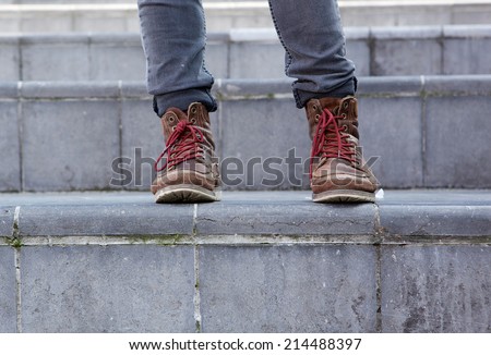 Close up male leather boots on steps