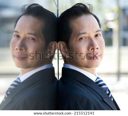 Close up portrait of an asian businessman with mirror reflection