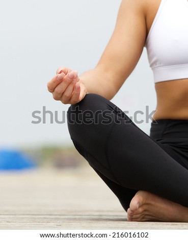 Close up portrait of a young woman hands in yoga pose outdoors