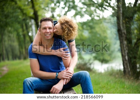 Portrait of a loving couple with woman kissing man