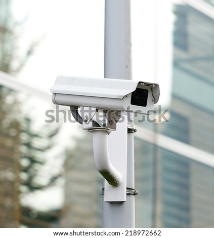 CCTV security camera looking and recording in the city