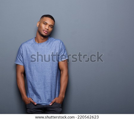 Portrait of a cool african american guy posing on gray background