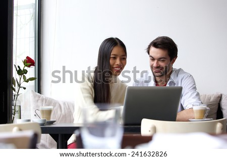Portrait of a young man and woman working on laptop