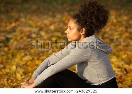 Side view portrait of a young african american sports woman resting outdoors