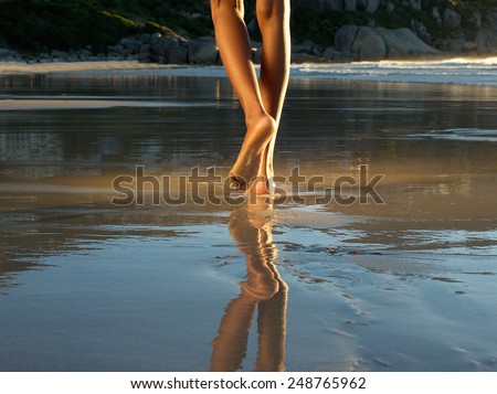 Low angle african american woman walking alone on the beach