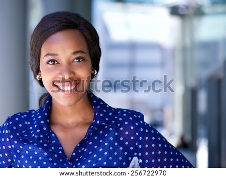 Close up portrait of a happy business woman smiling outside office building