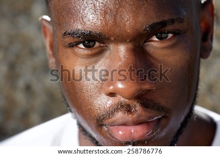 Close up portrait of a handsome sports man sweating after work out exercise