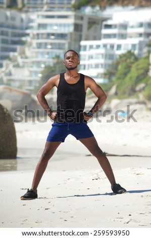 Healthy man standing outdoors doing breathing exercises