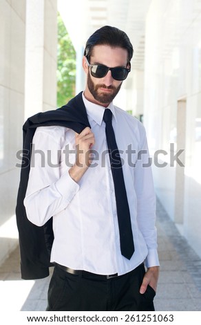 Portrait of a male fashion model in shirt and tie posing outside
