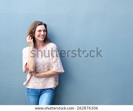 Portrait of an attractive mid adult woman smiling with hand in hair